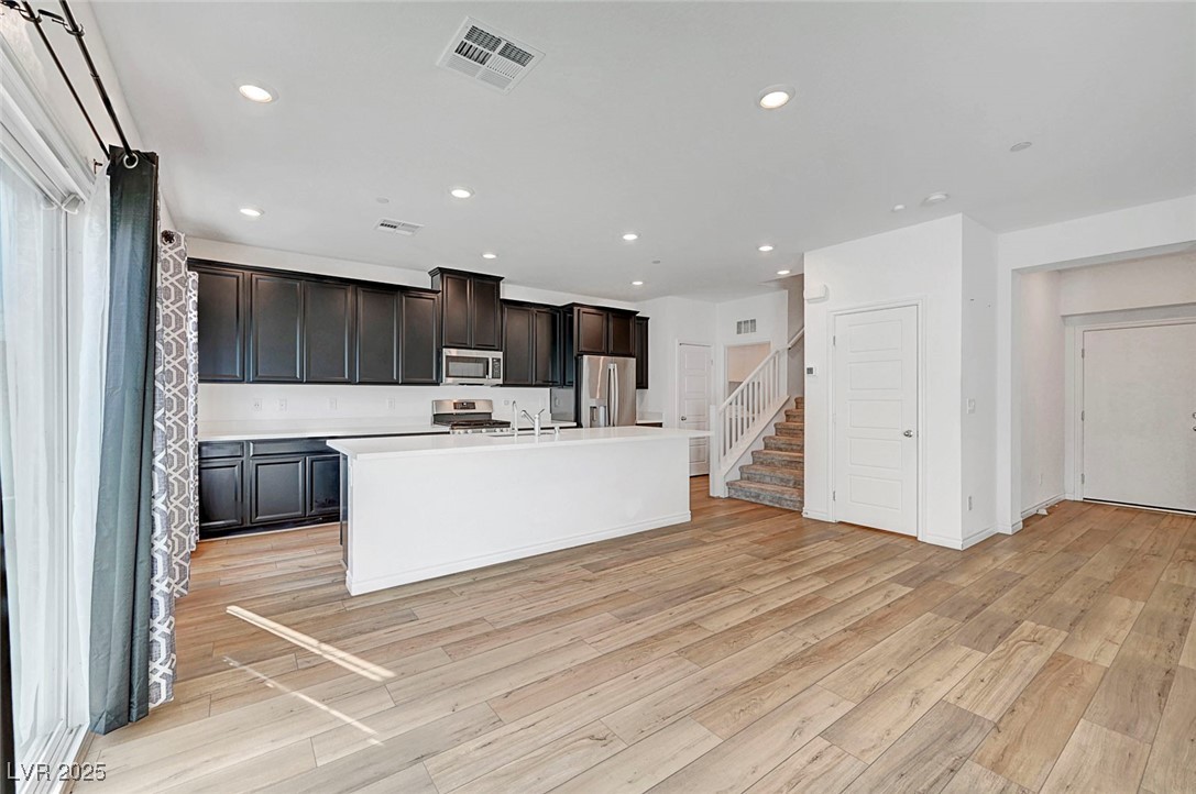 7204 North Decatur Boulevard North Las Vegas, NV 89084 - Photo 18 of 55 Kitchen with recessed lighting, stainless steel appliances, a sink, light wood-style floors, and visible vents