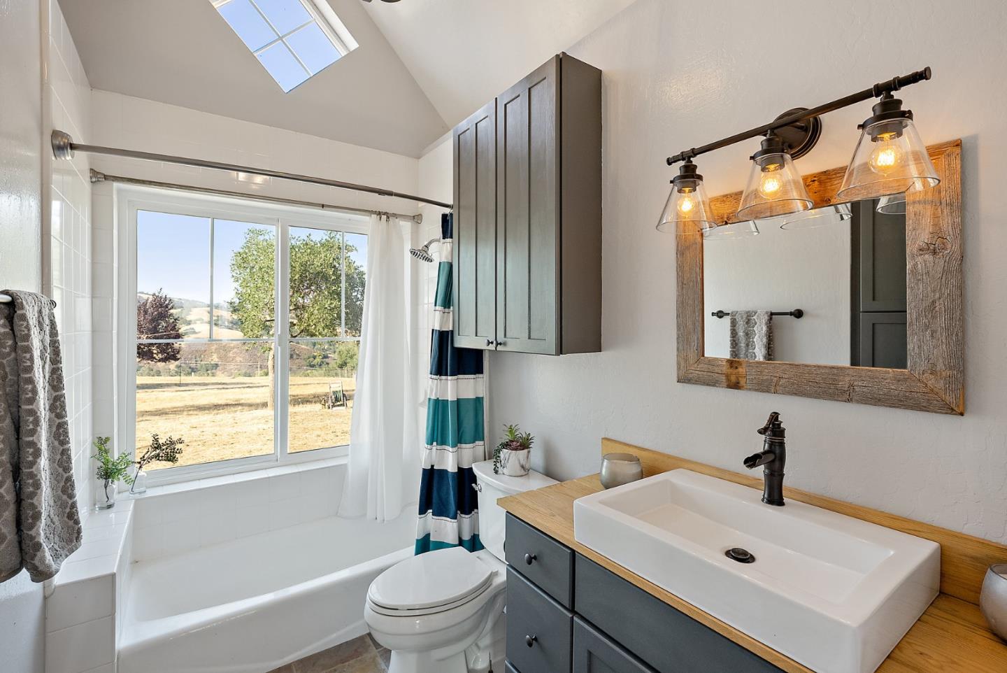 16650 Finley Ridge Road Morgan Hill, CA 95037 - Photo 19 of 85 a bathroom with a sink toilet a mirror and shower