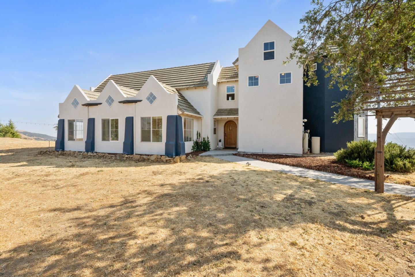 16650 Finley Ridge Road Morgan Hill, CA 95037 - Photo 3 of 85 a view of a white house with a yard and large tree