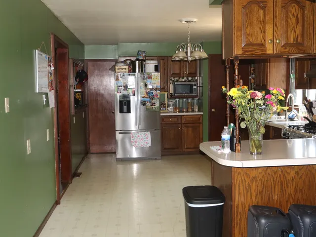 a kitchen with refrigerator and microwave