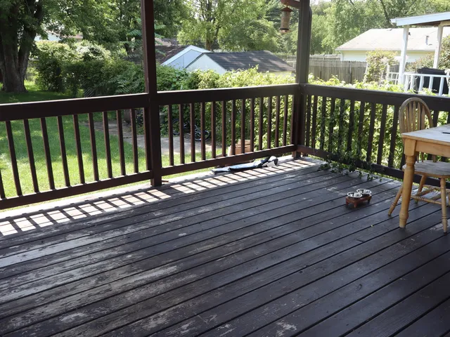 a view of balcony with wooden floor