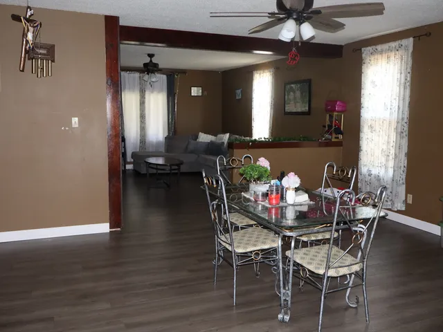 a view of a dining room with furniture and wooden floor