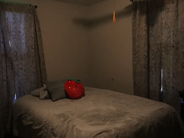 a bed sitting in a bedroom next to a shower