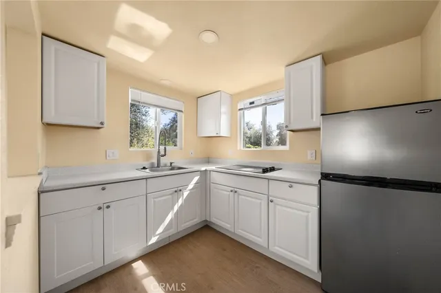 a kitchen with sink and cabinets