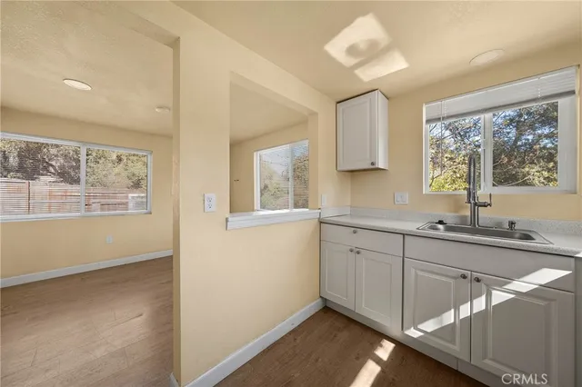 a kitchen with sink cabinets and window