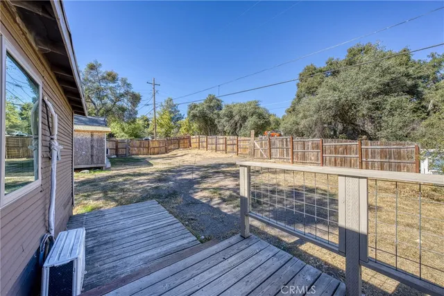 a backyard of a house with barbeque oven and outdoor seating