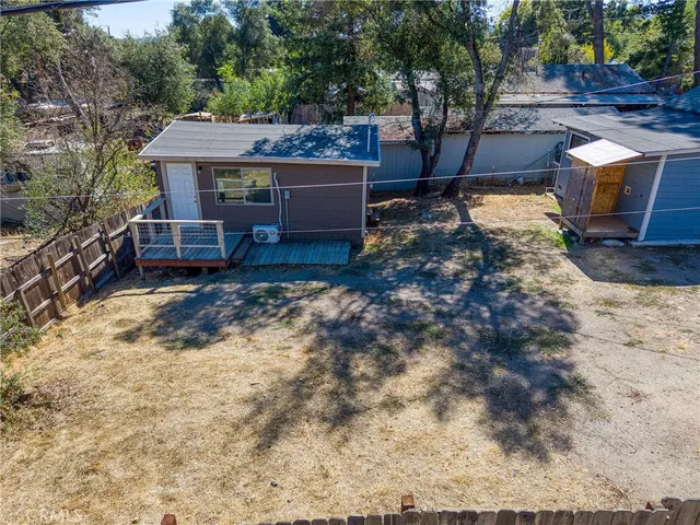 a view of a backyard with wooden fence