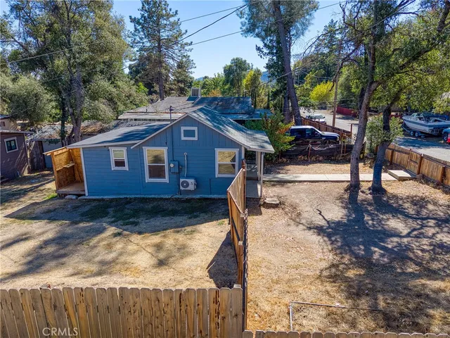 a view of a house with wooden fence