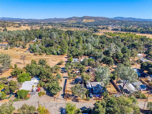 a view of a lush green hillside and a houses