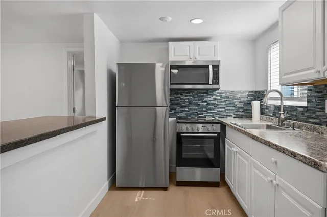 a kitchen with a refrigerator sink and microwave