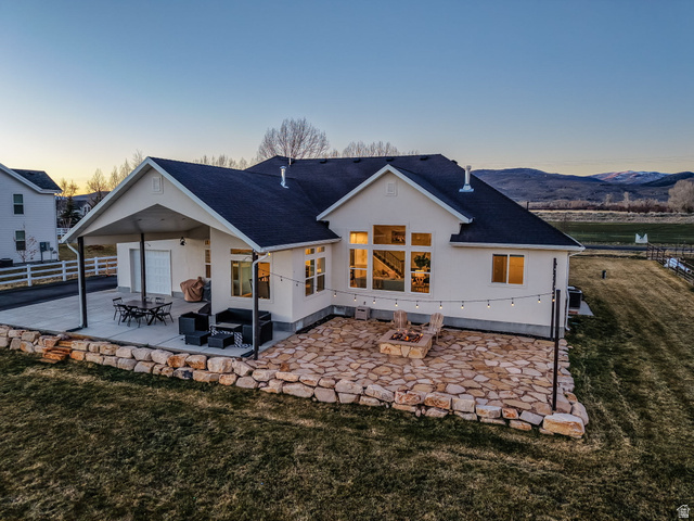 352 East Boulderville Road Oakley, UT 84055 - Photo 3 of 62 Back of house featuring a patio, a shingled roof, and stucco siding