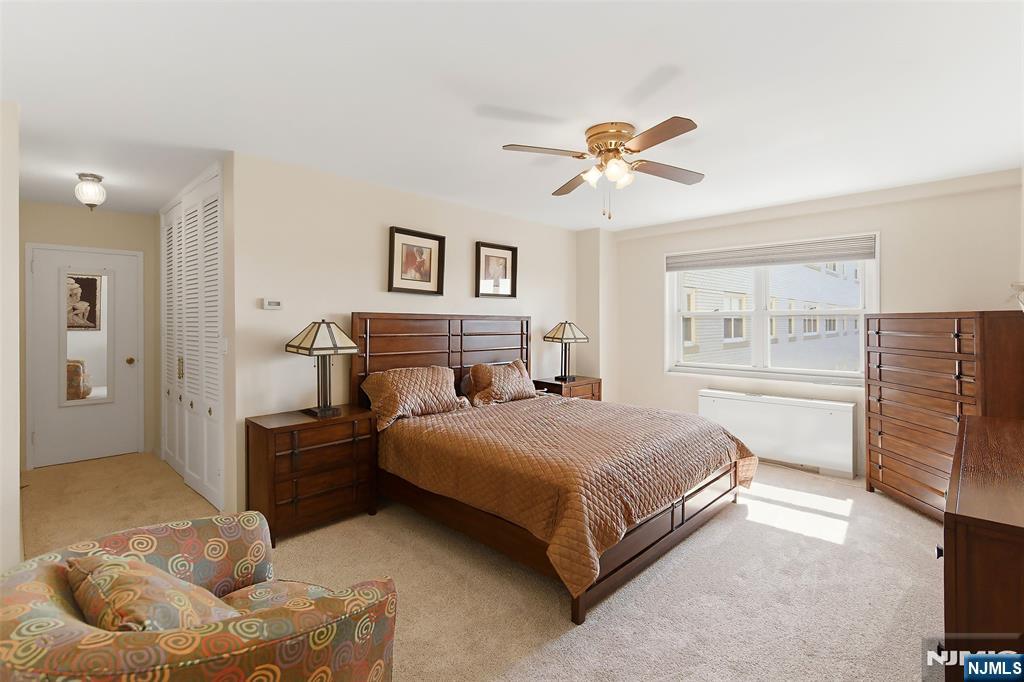 280 Prospect Avenue, Unit 8G Hackensack, NJ 07601 - Photo 16 of 23 a bedroom with a bed and ceiling fan