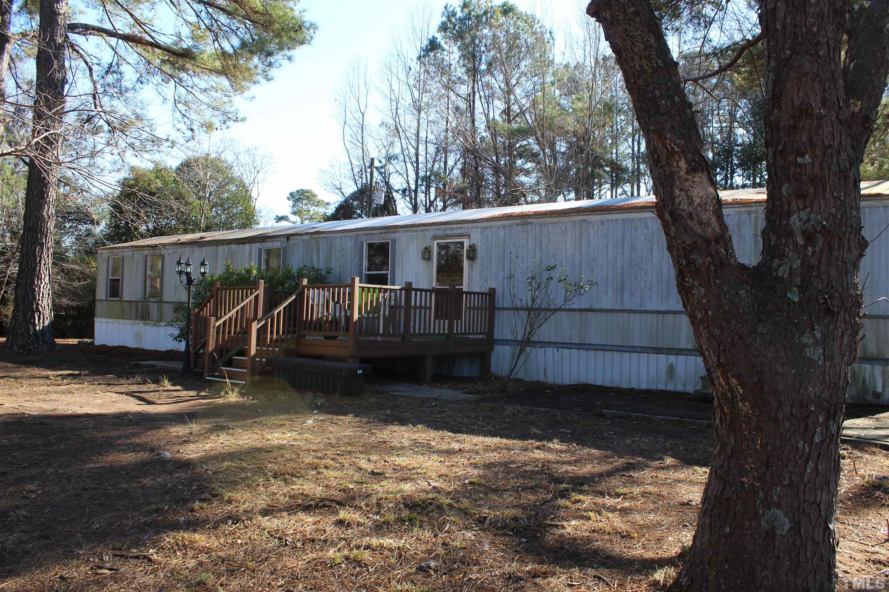 3617 Banks Road Raleigh, NC 27603 - Photo 1 of 37 a view of a backyard with large trees and a wooden fence