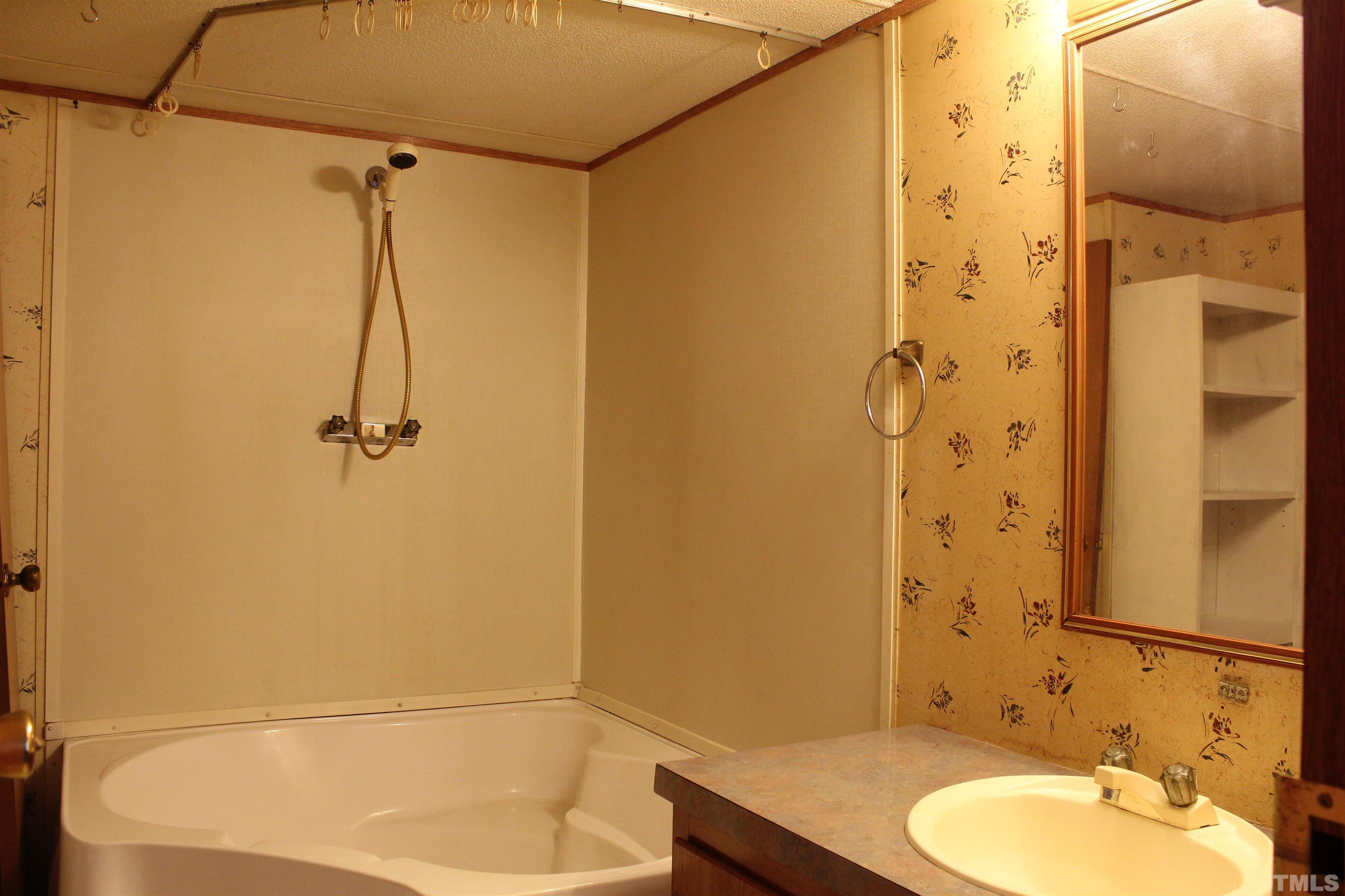 3617 Banks Road Raleigh, NC 27603 - Photo 29 of 37 a bathroom with a granite countertop shower sink and a mirror