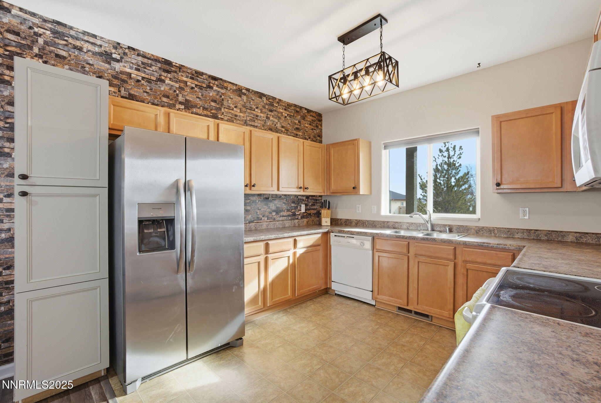 365 Orrcrest Drive Reno, NV 89506 - Photo 8 of 21 a kitchen with granite countertop stainless steel appliances a refrigerator a sink a stove a microwave oven and a window