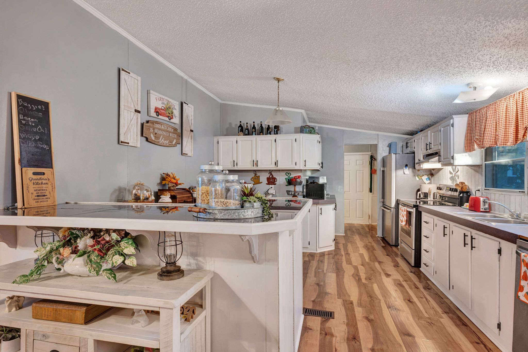 944 Deason Road Dickson, TN 37055 - Photo 11 of 28 a kitchen with granite countertop lots of clutter and stainless steel appliances