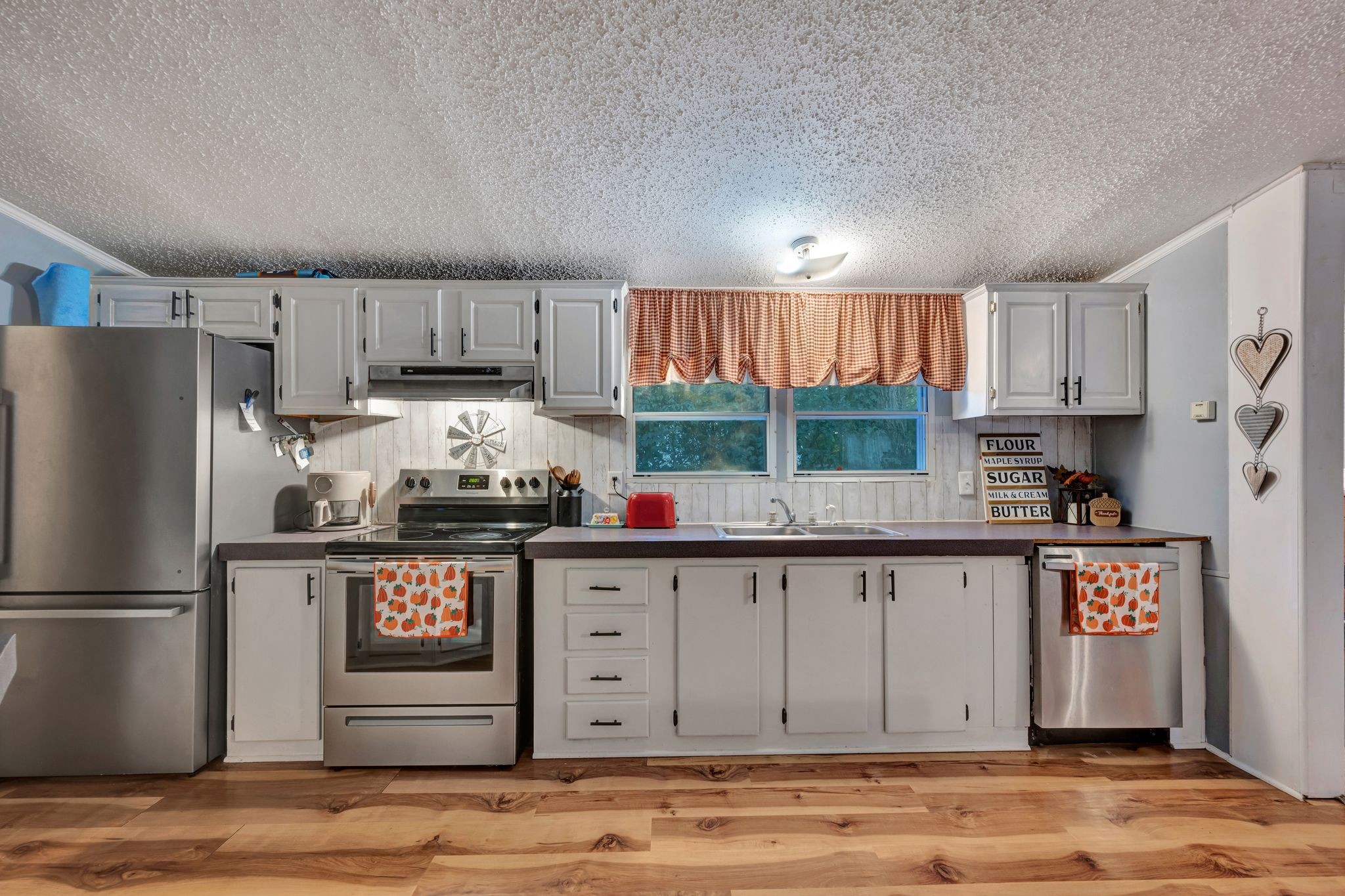 944 Deason Road Dickson, TN 37055 - Photo 13 of 28 a kitchen with granite countertop a refrigerator and a sink