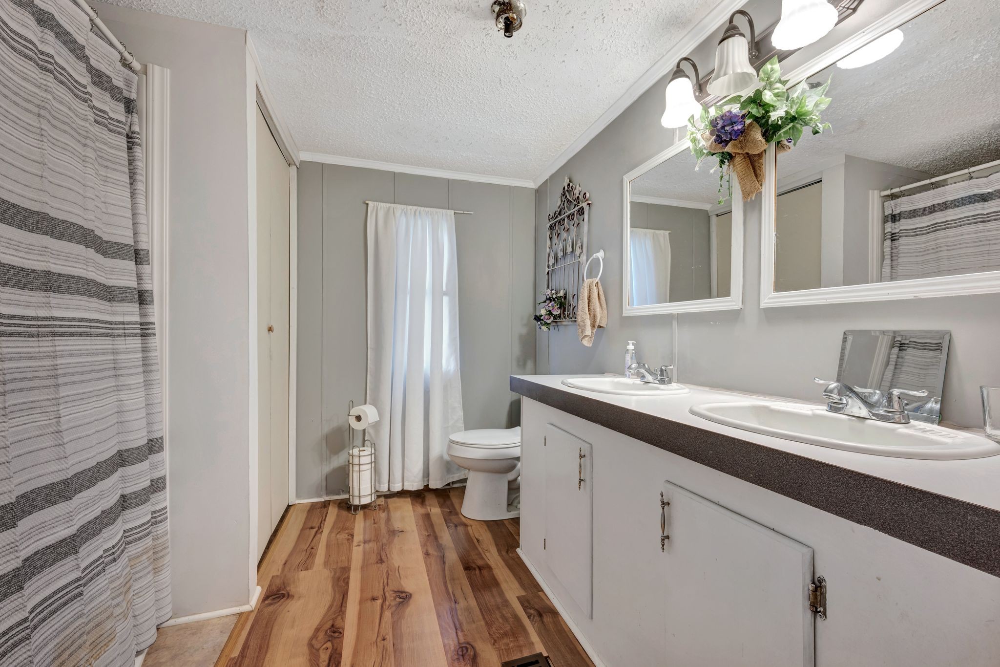 944 Deason Road Dickson, TN 37055 - Photo 19 of 28 a spacious bathroom with a granite countertop sink a toilet a large mirror and shower