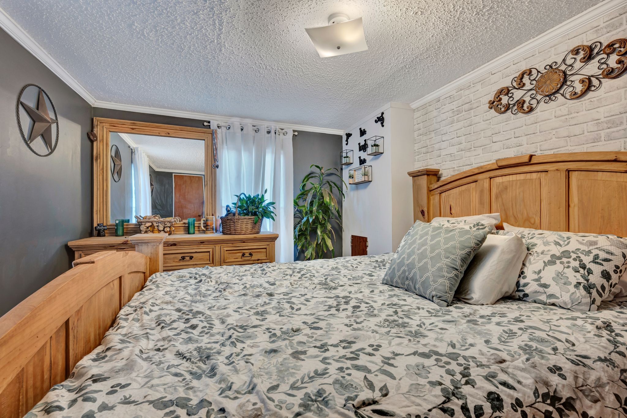 944 Deason Road Dickson, TN 37055 - Photo 21 of 28 a bedroom with a large bed and a large mirror on dresser