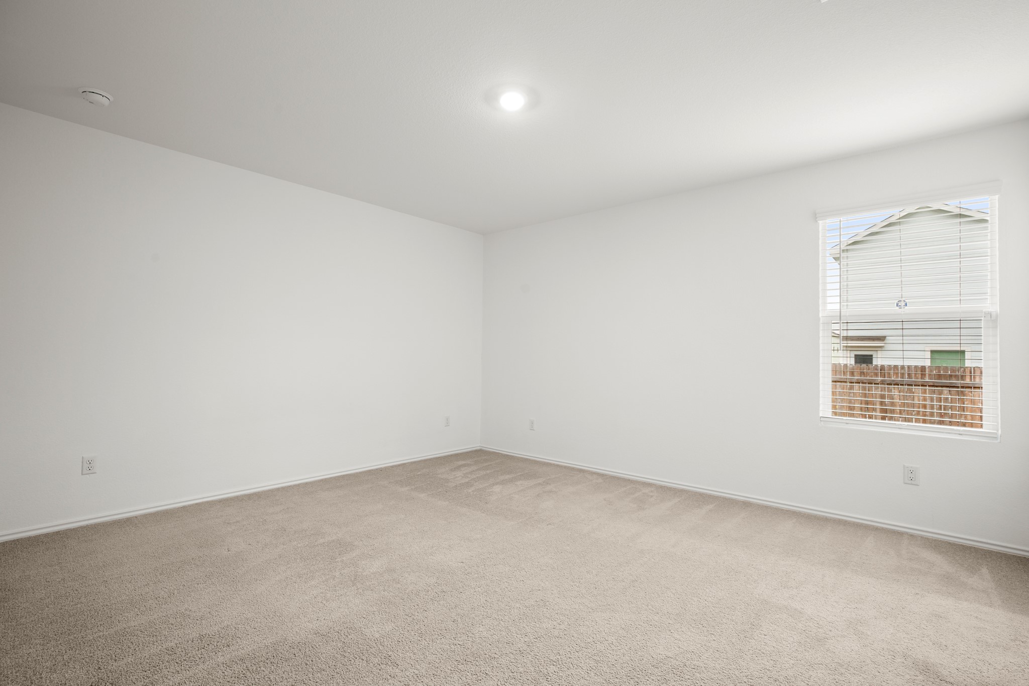 125 Gabbro Gardens Maxwell, TX 78656 - Photo 11 of 24 Enjoy your own private, secluded primary suite with cozy carpeting, high ceilings, and recessed lighting.