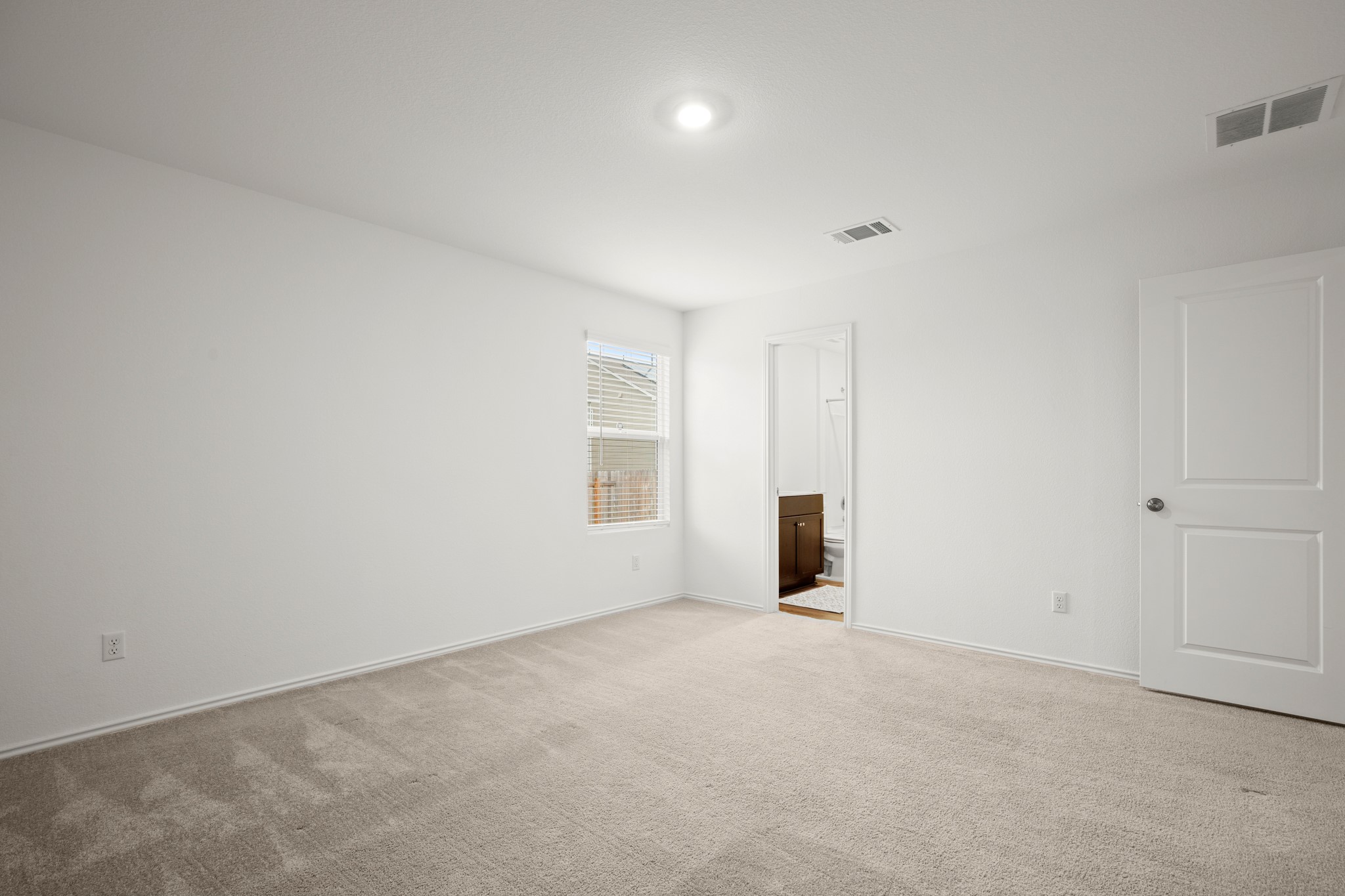 125 Gabbro Gardens Maxwell, TX 78656 - Photo 12 of 24 The primary suite comes with its own private ensuite bathroom with a walk-in closet.