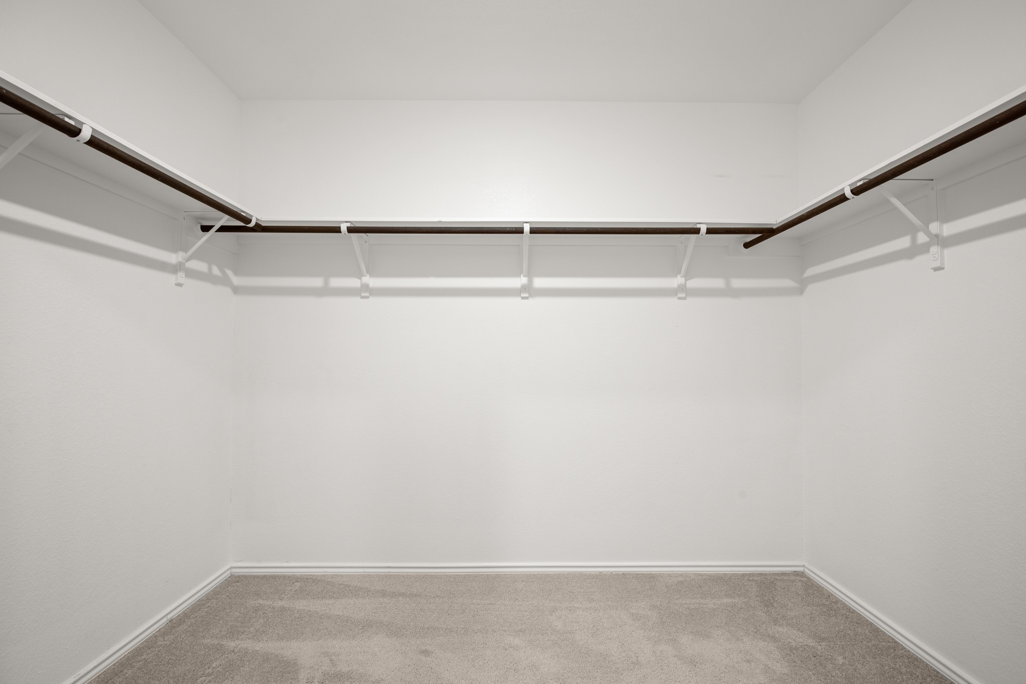 125 Gabbro Gardens Maxwell, TX 78656 - Photo 14 of 24 The primary walk-in closet is situated off the ensuite bath.