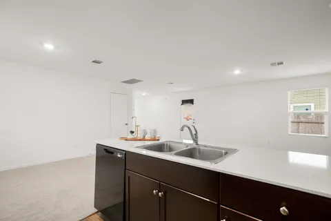 a view of a living room hardwood and a kitchen