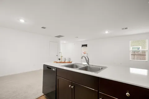 a view of a living room hardwood and a kitchen