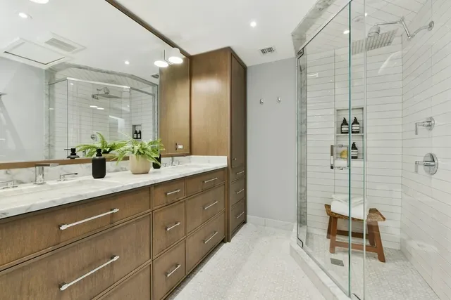 a bathroom with a double vanity sink and a mirror