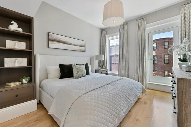 a bedroom with bed and window