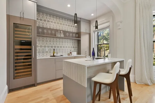 a kitchen with a sink cabinets and wooden floor