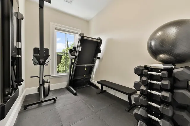 a room with gym equipment and a mirror