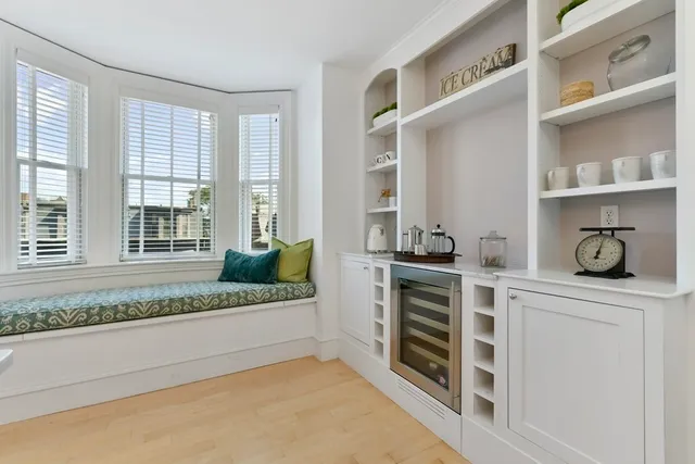 a bathroom with a granite countertop sink and washing machine