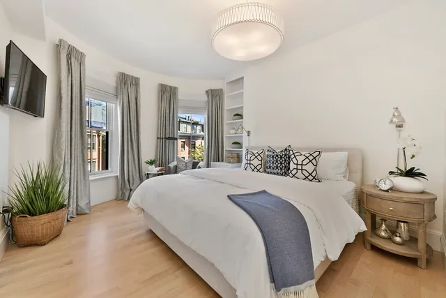 a bedroom with a large bed and tv