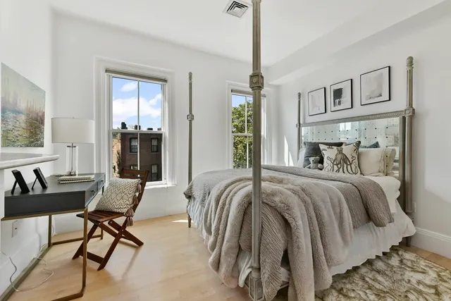 a bedroom with a bed and a chandelier