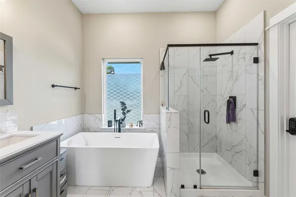 a bathroom with a bathtub and a sink