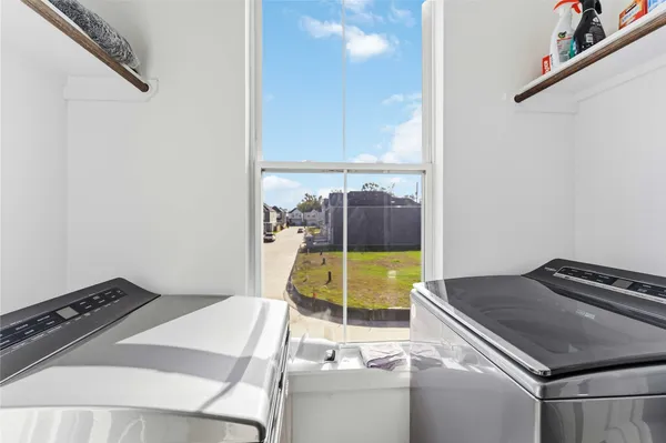 a kitchen with a stove and a view of living room