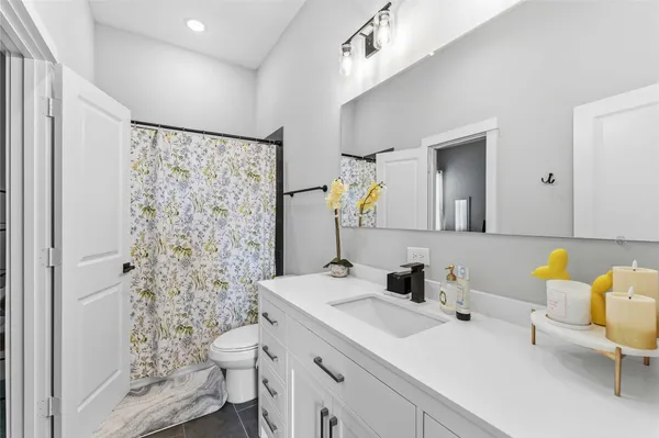 a bathroom with a sink toilet and shower