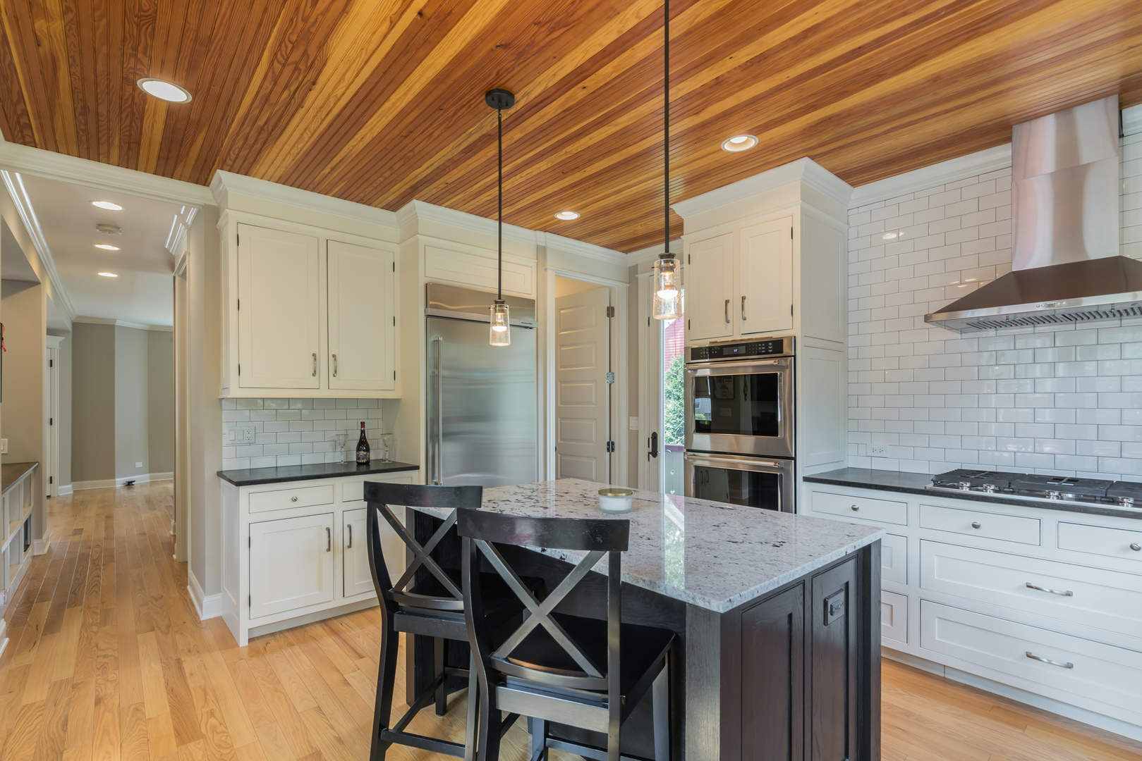 201 Spring Street Cary, IL 60013 - Photo 12 of 34 a kitchen with a table chairs refrigerator and cabinets