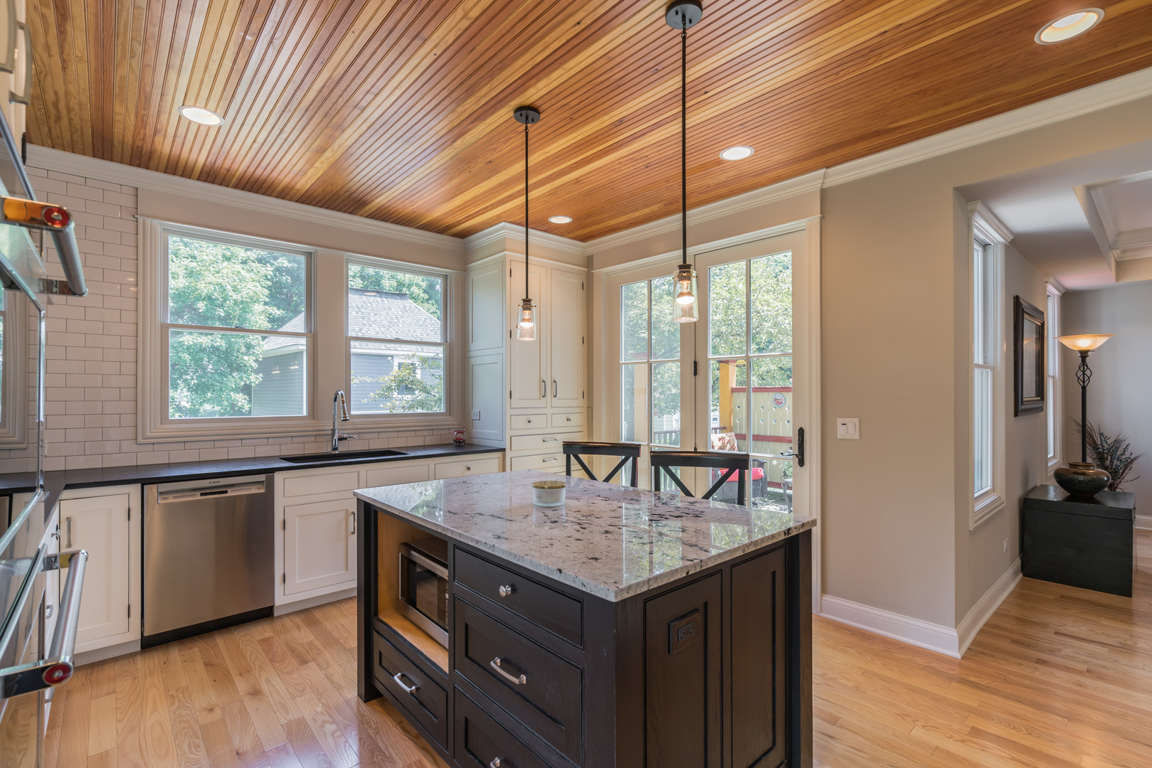 201 Spring Street Cary, IL 60013 - Photo 15 of 34 a kitchen with granite countertop a sink and wooden floor