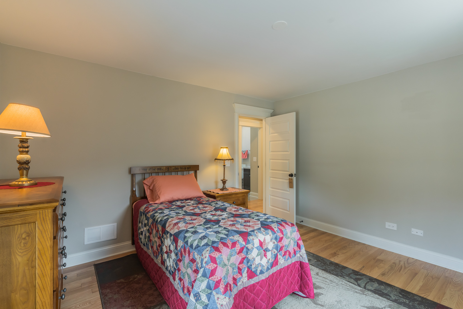 201 Spring Street Cary, IL 60013 - Photo 26 of 34 a bedroom with a bed and a lamp