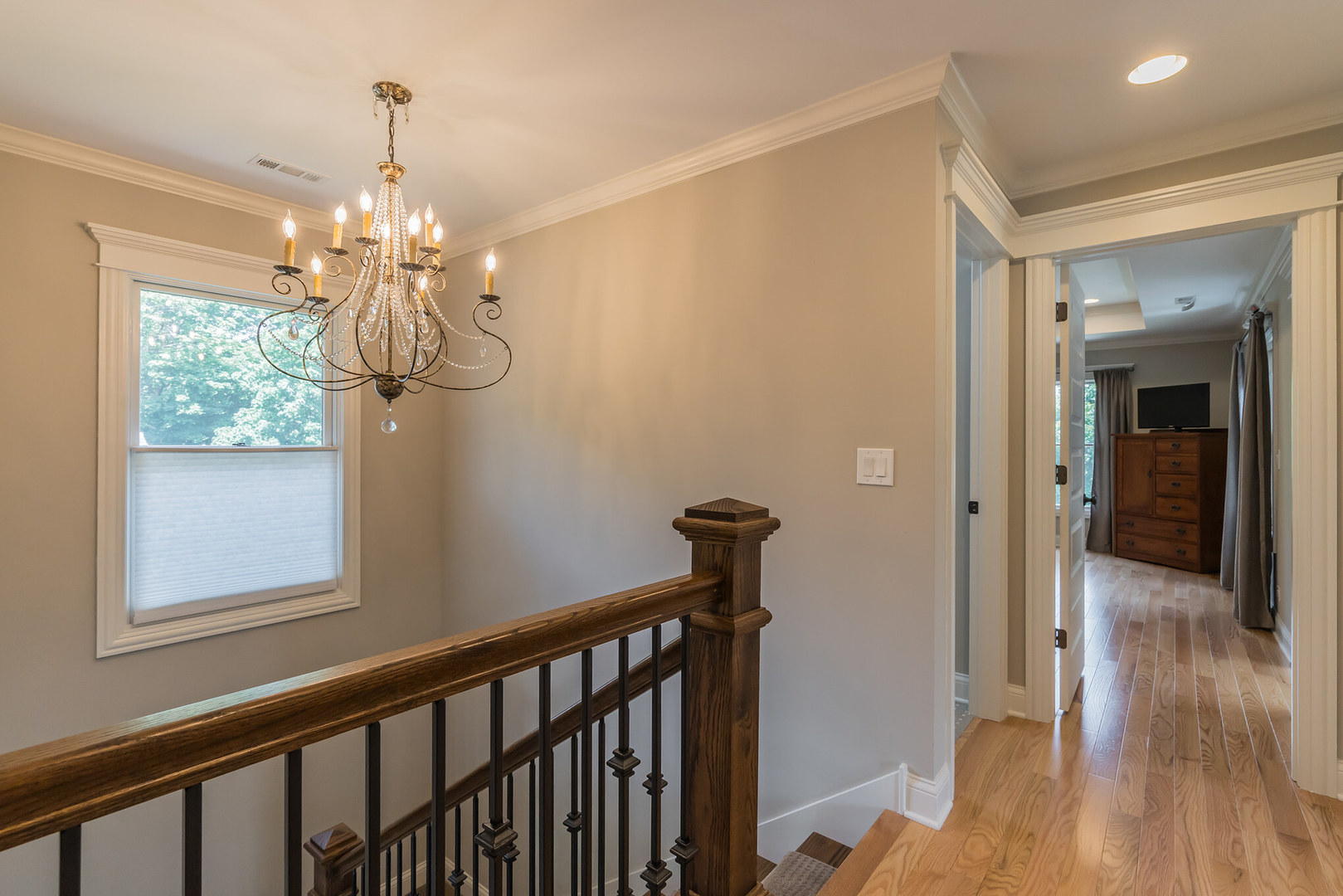 201 Spring Street Cary, IL 60013 - Photo 29 of 34 a view of a hallway with wooden floor and a chandelier