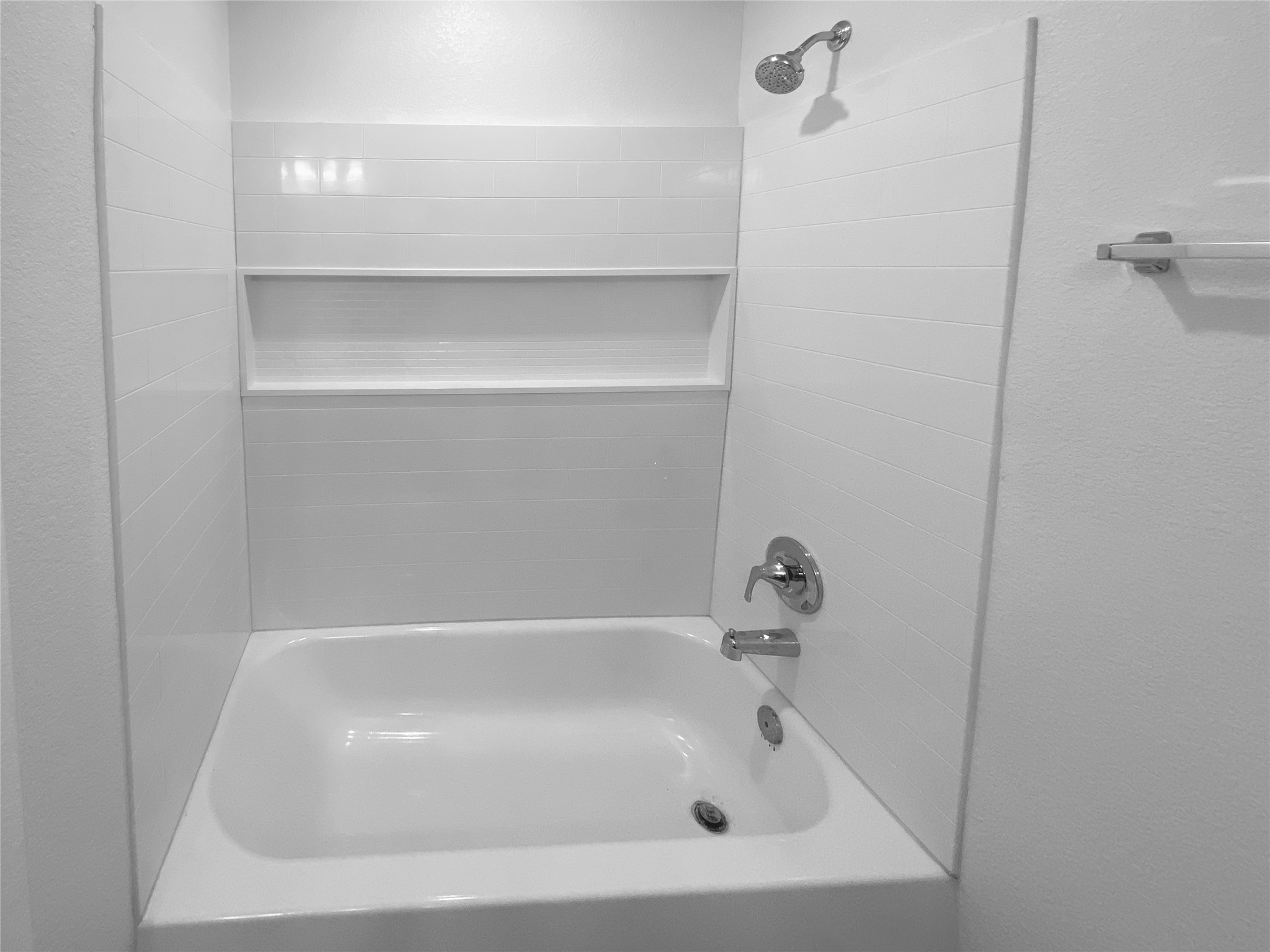932 Yellow Ribbon Trail Jarrell, TX 76537 - Photo 16 of 26 Full bathroom featuring a textured wall and shower / bathtub combination