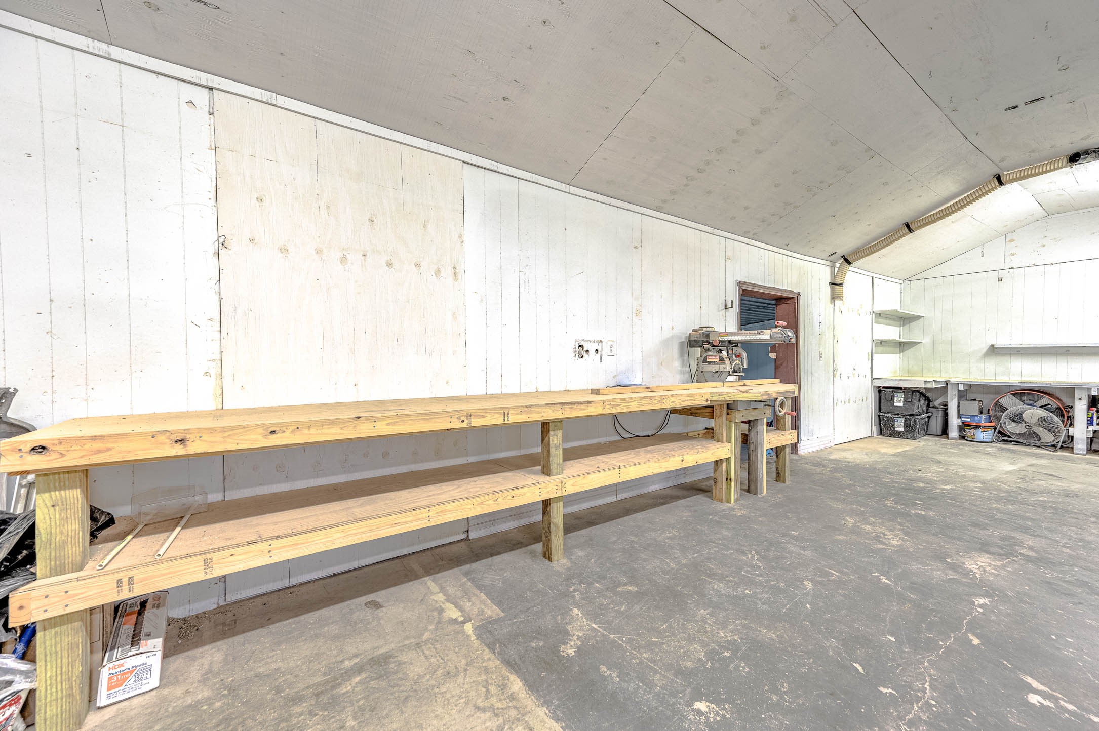 1619 County Road 387 Rosharon, TX 77583 - Photo 33 of 49 Attached workshop features workbenches and shelving.