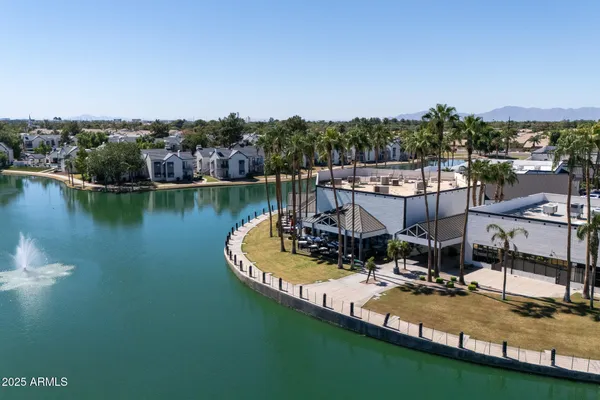 a view of swimming pool with outdoor seating and lake view