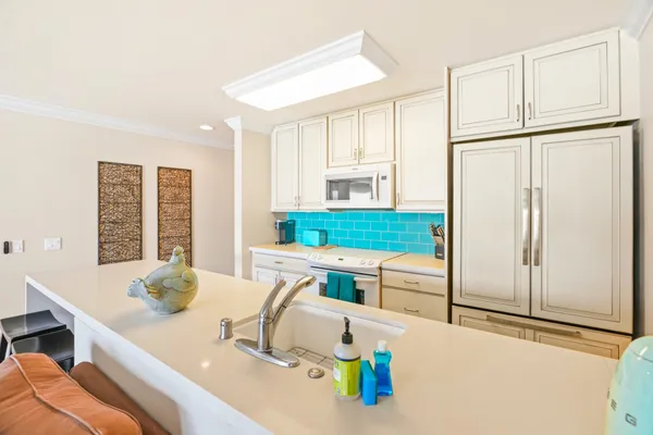 a kitchen with stainless steel appliances granite countertop a sink and a refrigerator
