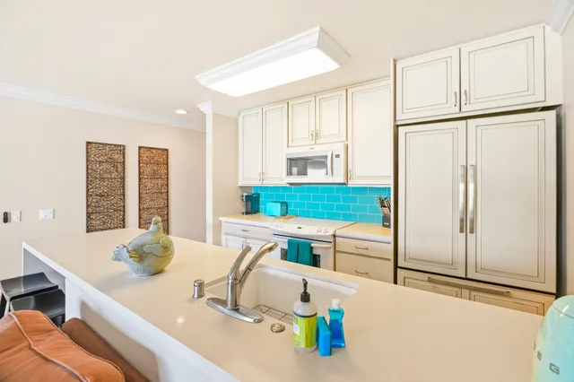 a kitchen with stainless steel appliances granite countertop a sink and a refrigerator
