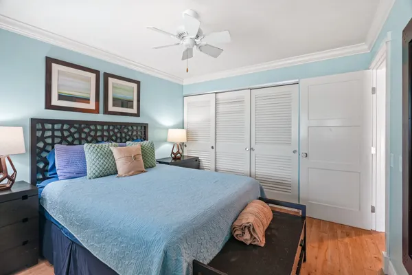 a bedroom with a bed and a chandelier