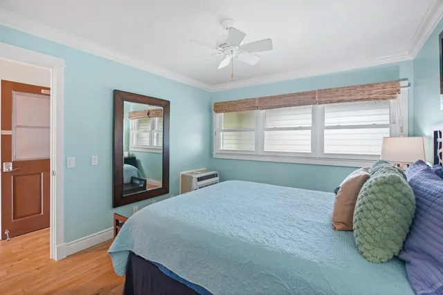 a bedroom with a bed and a mirror