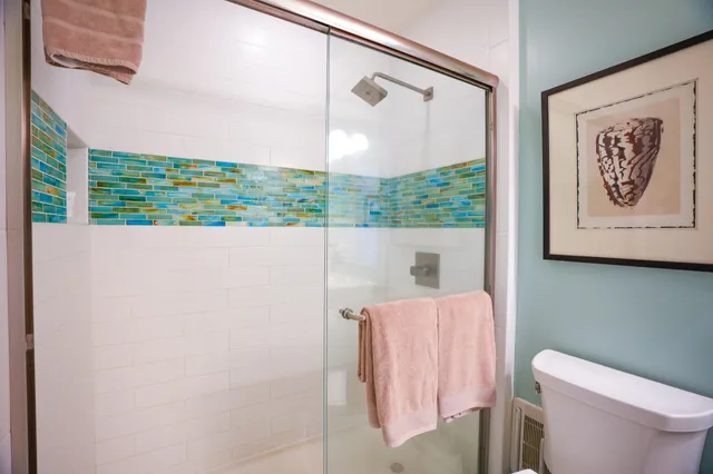 a picture of a room with a bed and a painting on the wall